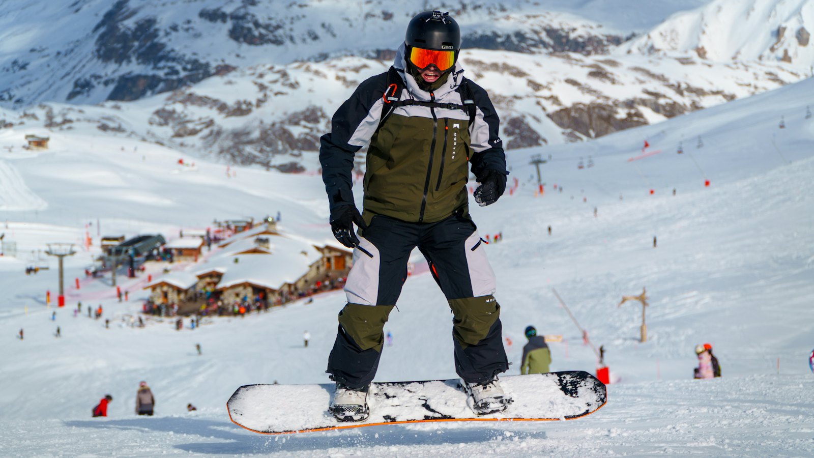 Snowboarder in a helmet and goggles on the slope