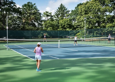 Family sports activity, parents with children playing tennis on outdoor court, healthy lifestyle